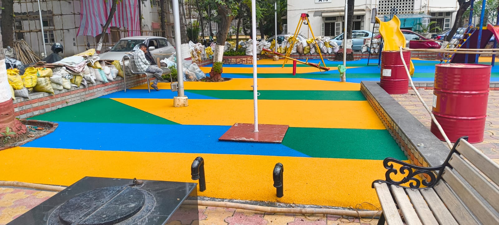 Multi-coloured EPDM wet pour play area in blue, green and yellow