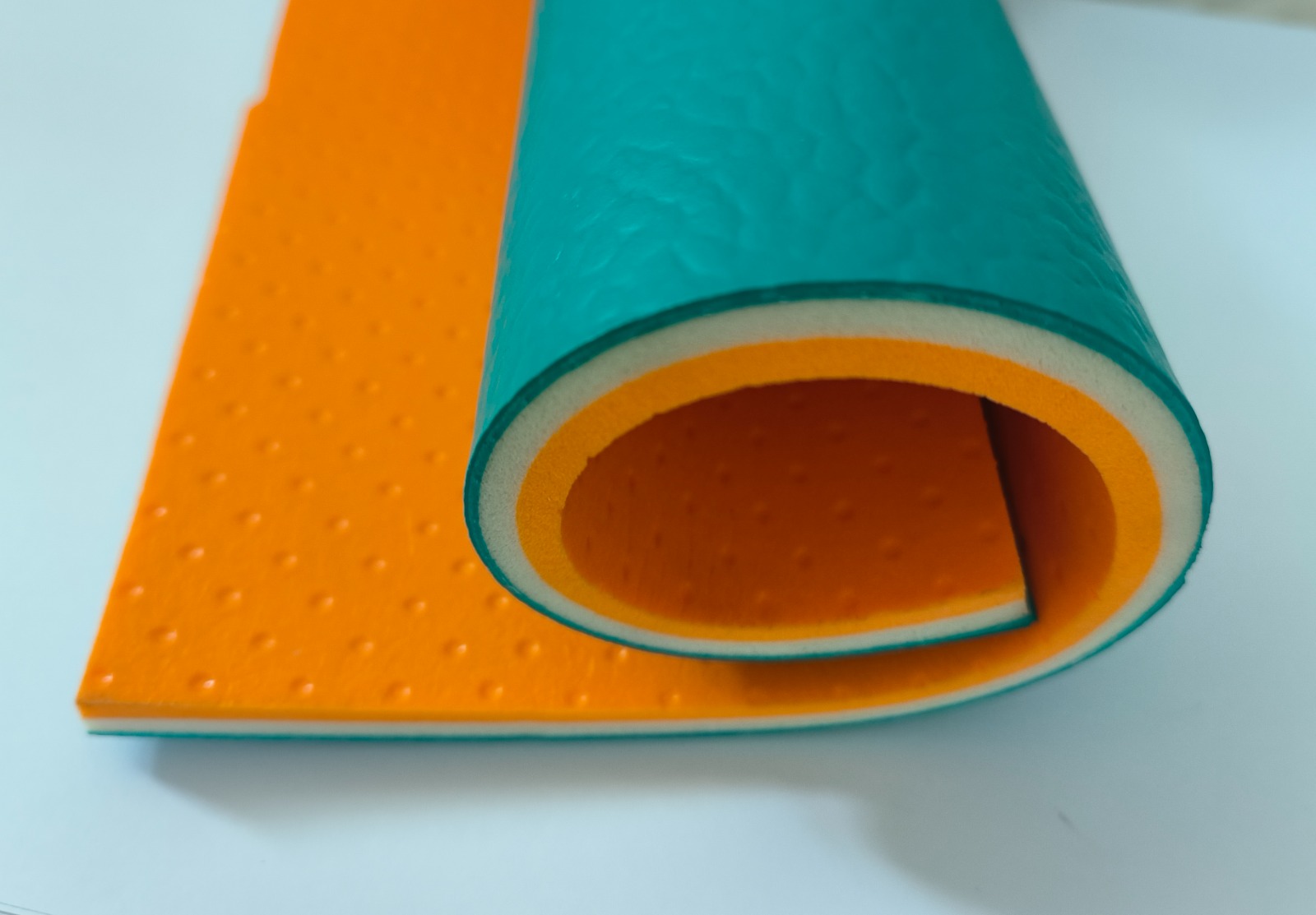 8 mm PVC vinyl roll cross-section in teal green showing the layered build-up