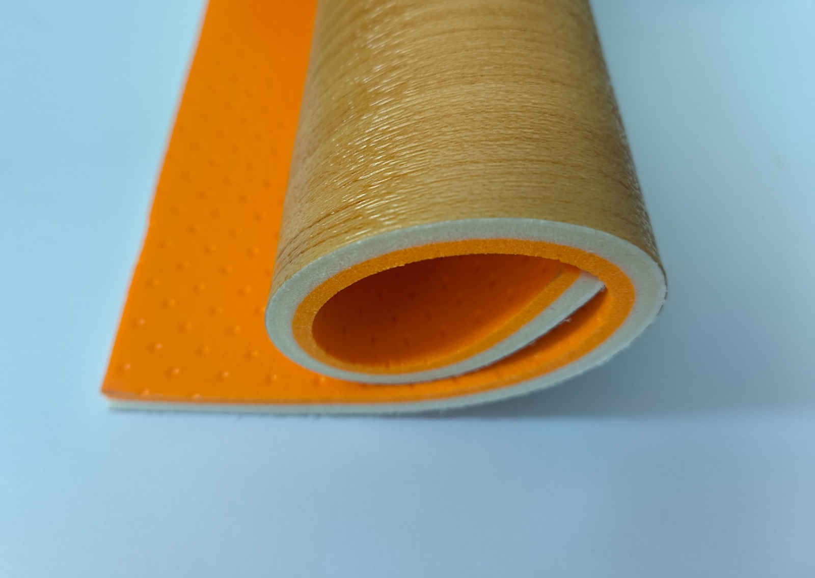 8 mm PVC vinyl roll cross-section in oakwood finish showing the foam core