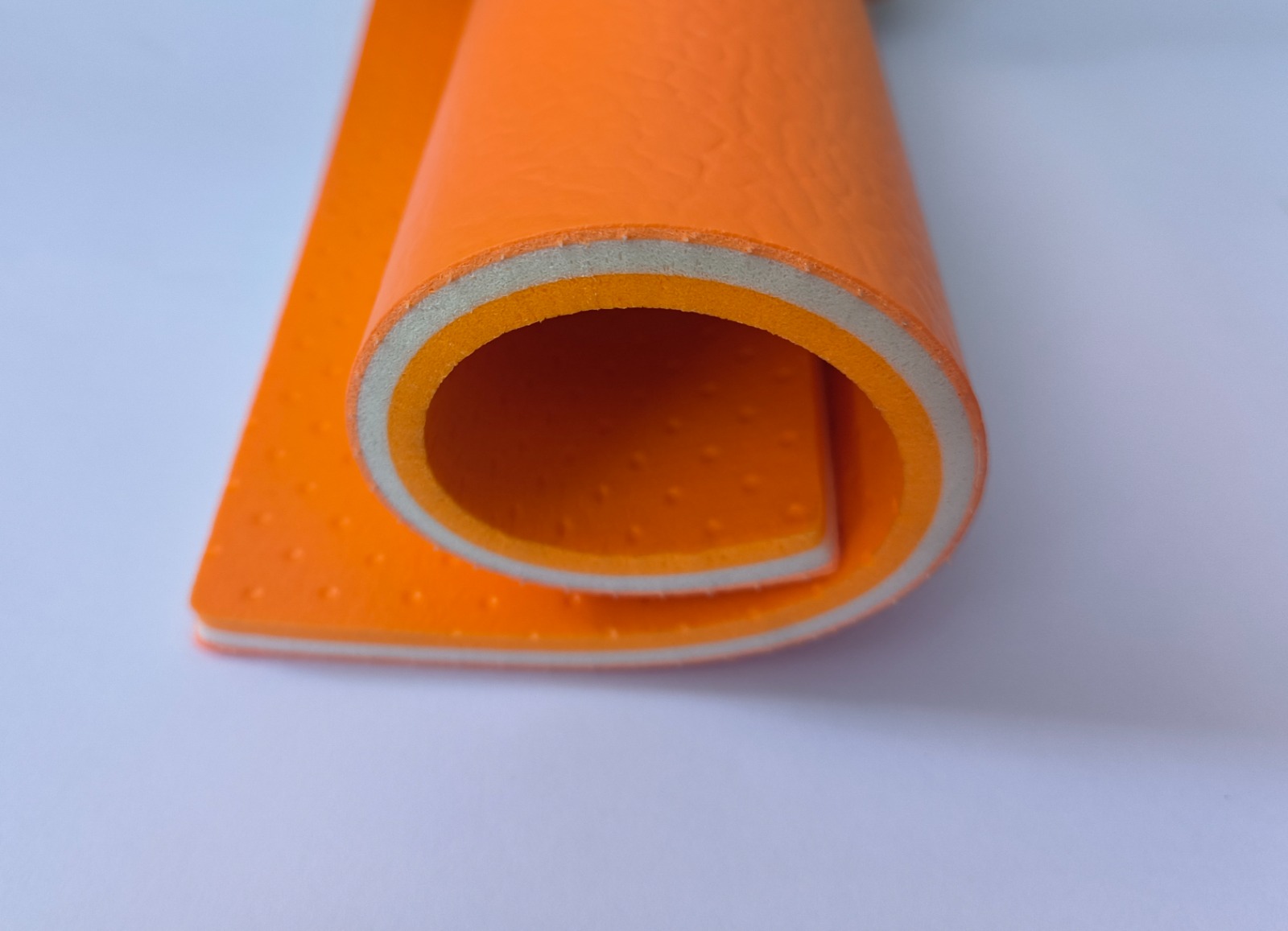 8 mm PVC vinyl roll cross-section in orange showing the embossed surface
