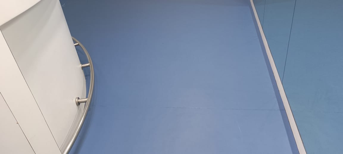Blue PVC vinyl sports flooring laid across an indoor court