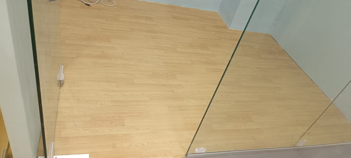 Maplewood finish PVC vinyl flooring in a studio with glass partition