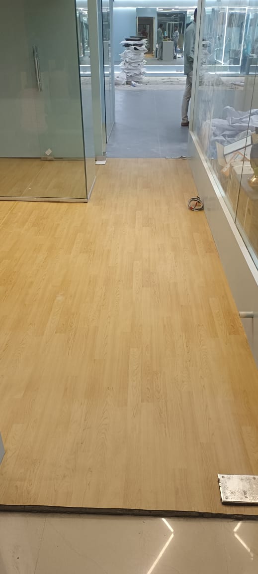 Wood finish PVC vinyl flooring running the length of a studio