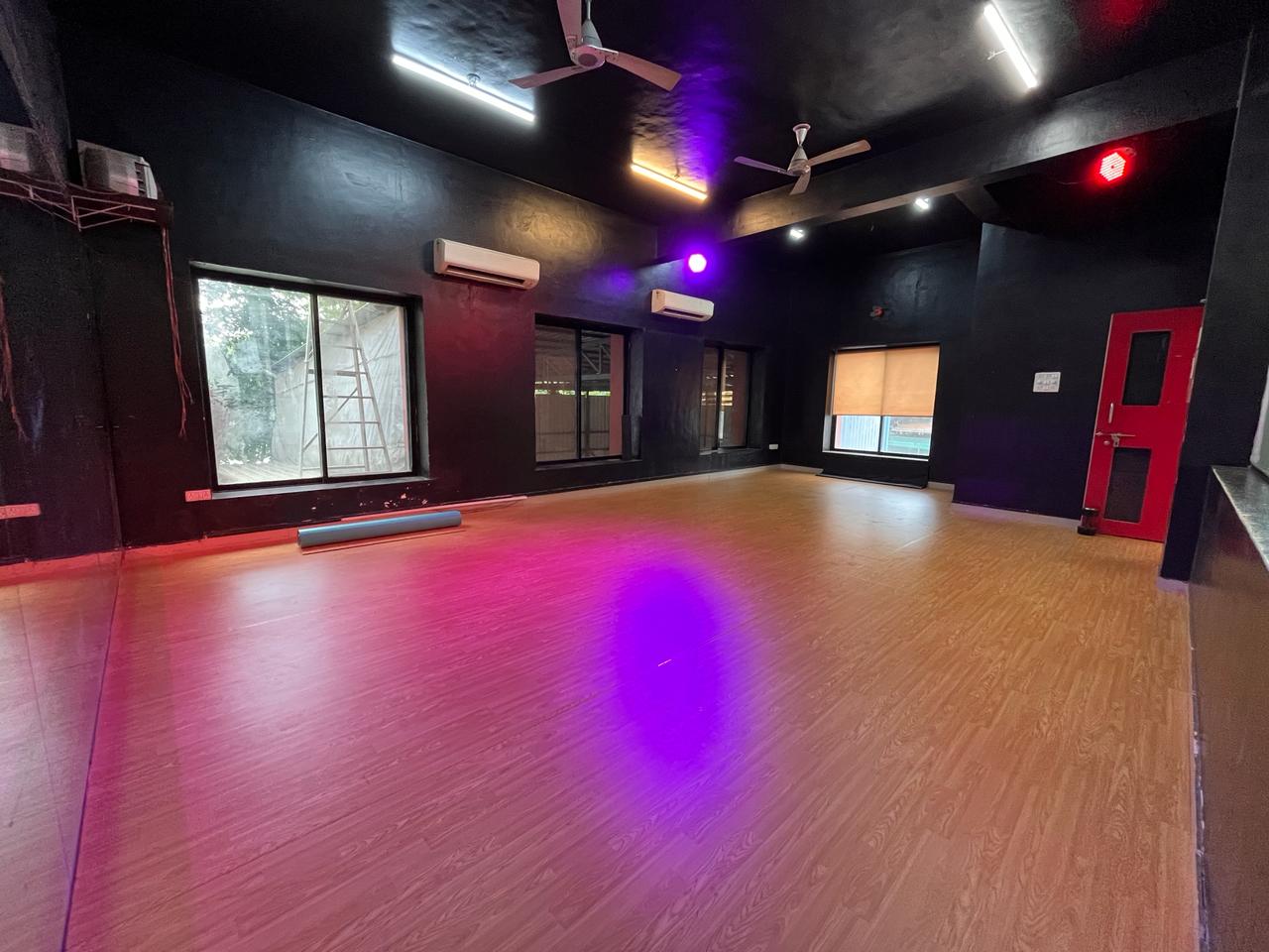 Wood finish PVC vinyl flooring in a dance and fitness studio with coloured lighting