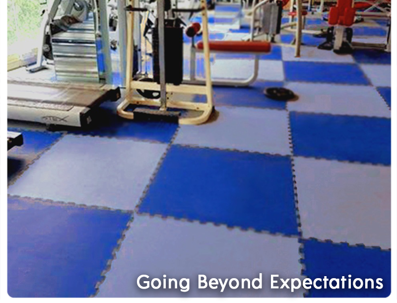 Tuffloor interlocking rubber tiles in metallic blue and silver grey joined edge to edge beside gym equipment