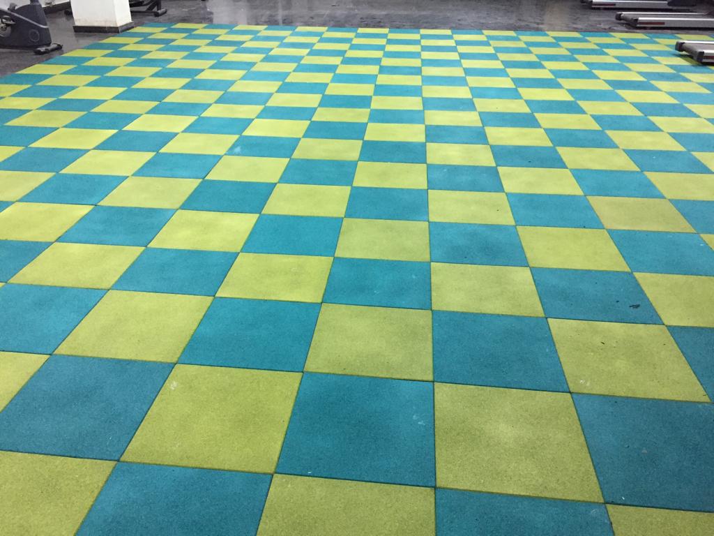 Peacock green and apple green square rubber tiles in a chequered layout