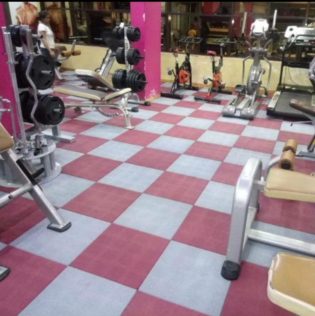 Tuffloor square rubber tiles in magenta and silver grey installed across a commercial gym floor