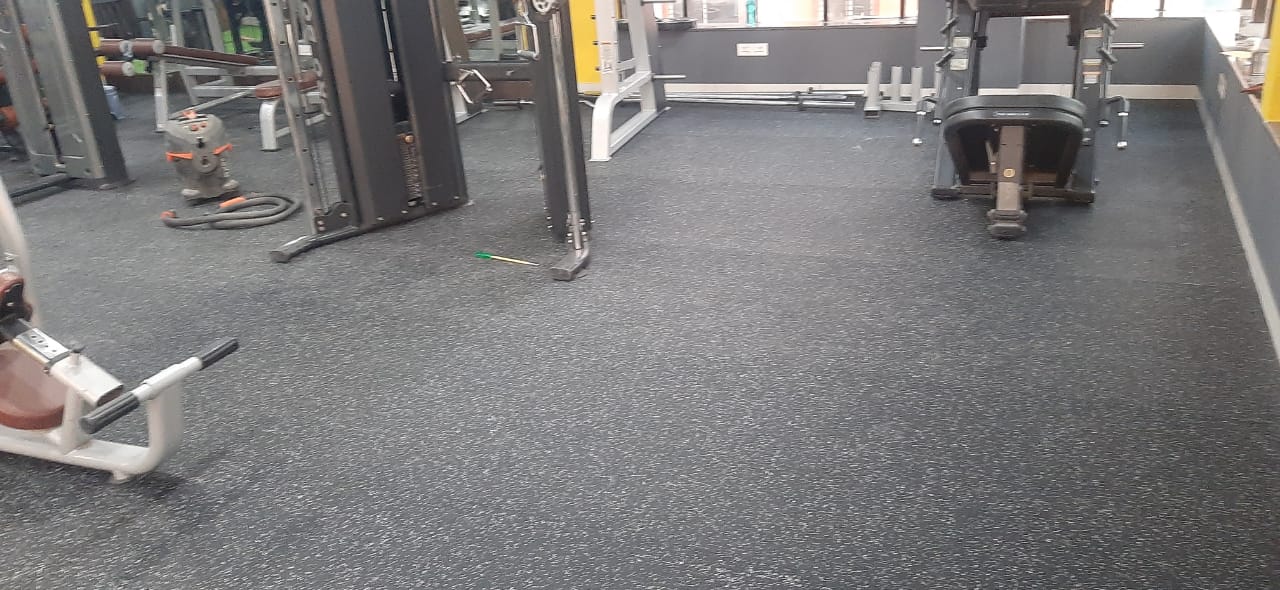EPDM rubber roll flooring in a gym with leg press and cable machines