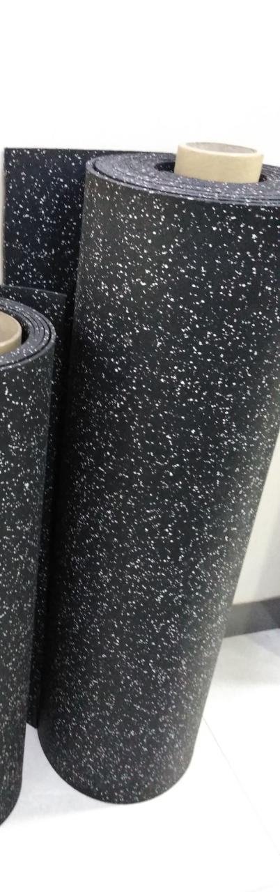 EPDM rubber rolls stored upright showing the black with white sparkle surface