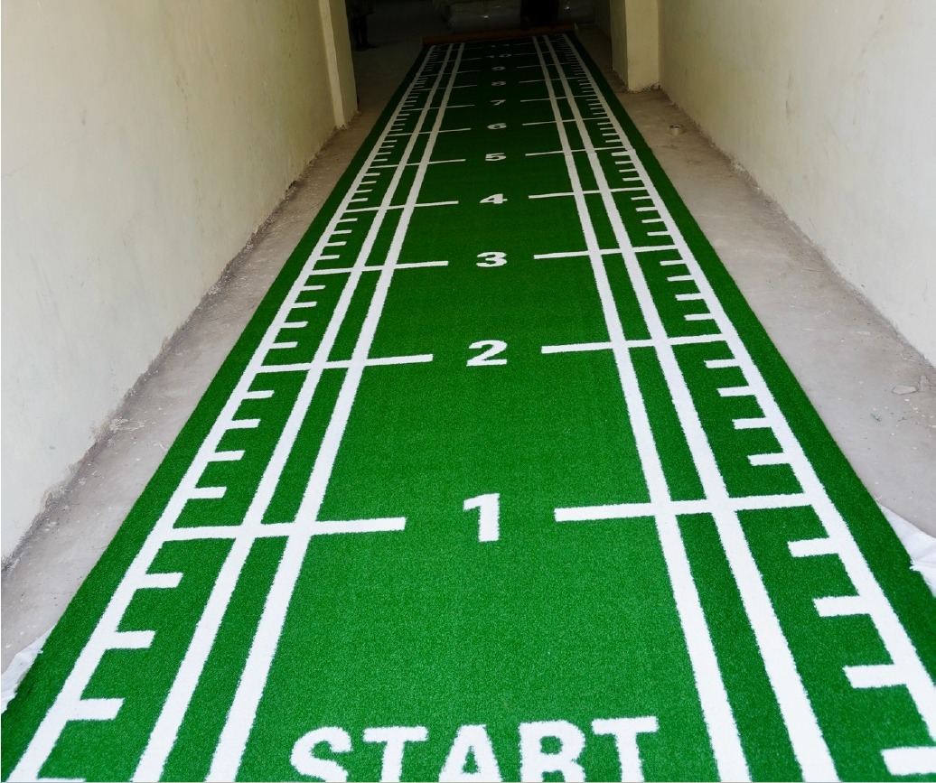 Green Astro Turf sled track with START marking and lane numbers