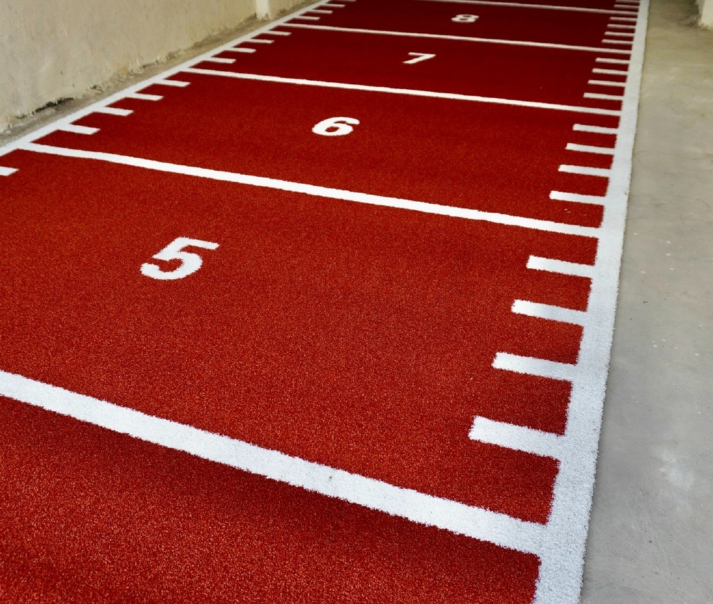 Red Astro Turf track surface with white metre markings