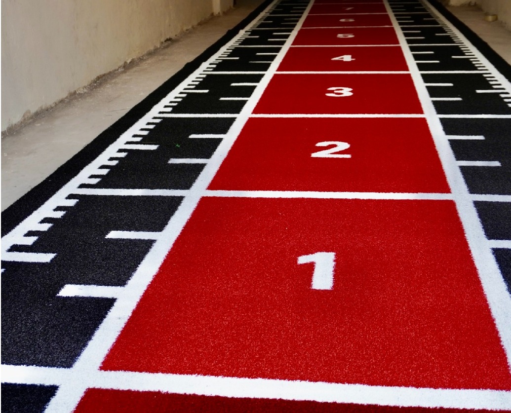 Black and red Astro Turf track viewed along its length