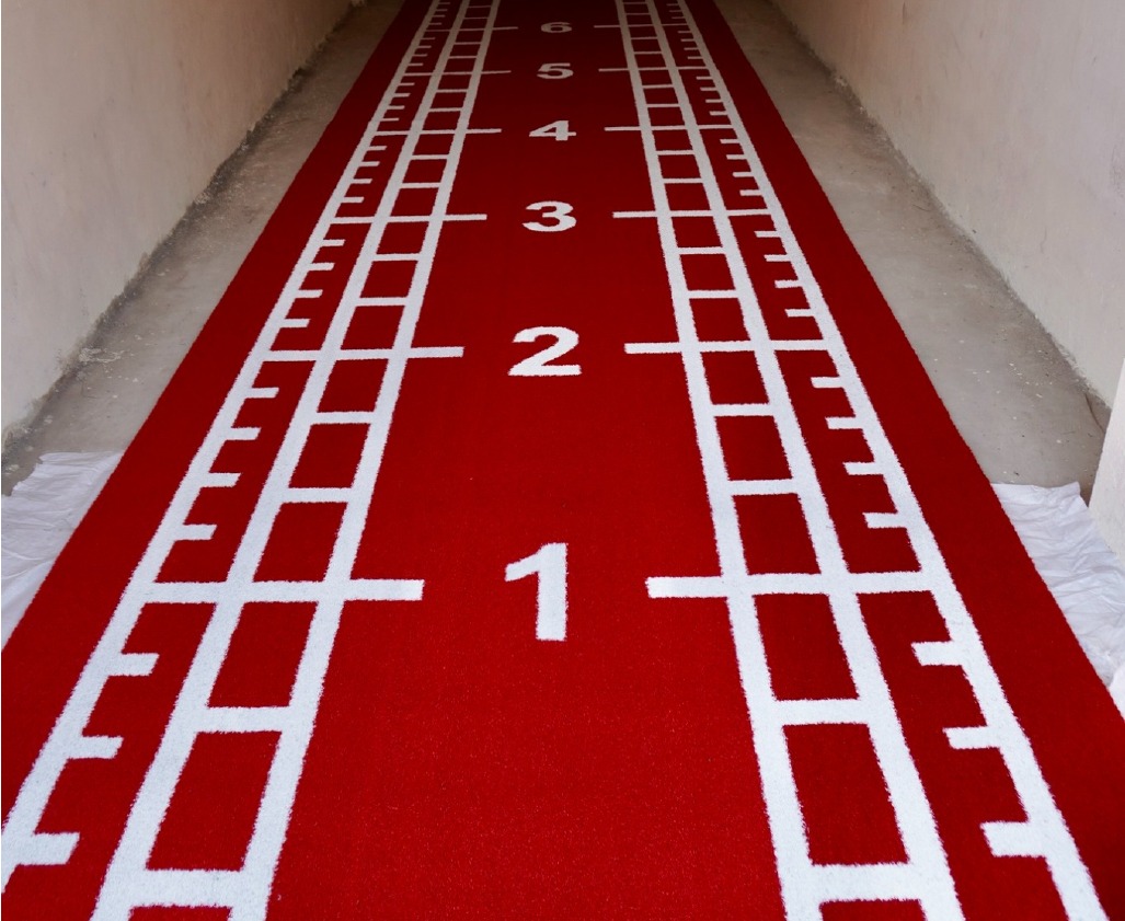 Red Astro Turf track with numbered distance markers